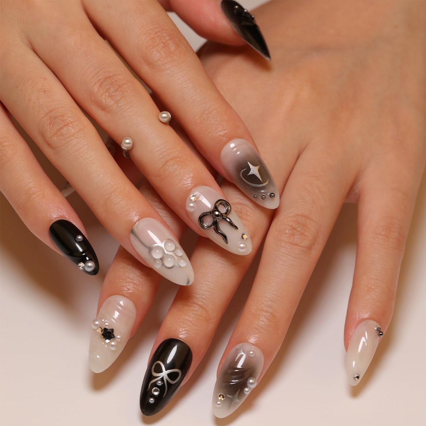 24PCS Black Press on Nails Medium Almond Fake Nails with 3D Alloy Bow Pearl Design Silver Shining Star Full Cover False Nails Water Drops French Tips Cute Stick on Nails Acrylic Fingernails for Women